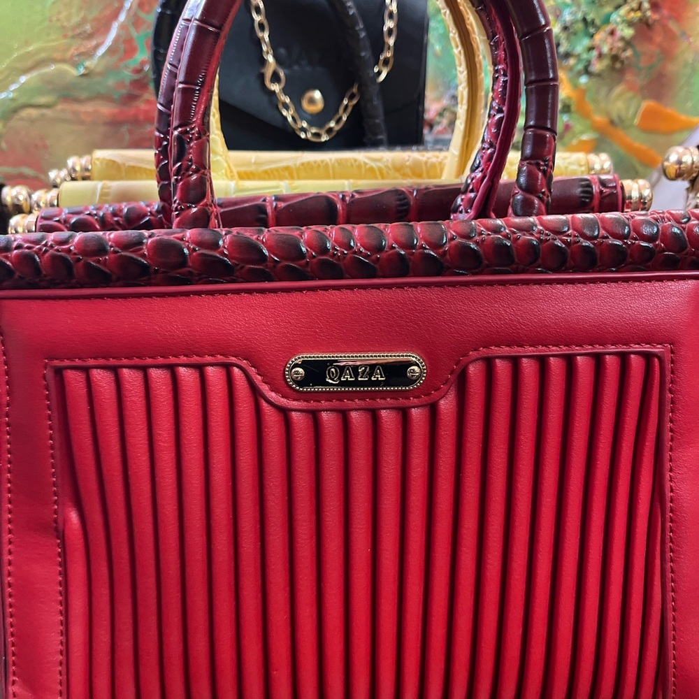 Red Satchel with Textured Detailing and Structured Shape